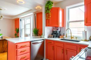 a kitchen with orange cabinets and a sink at Prime Location Top Rated Clean Parking Free! in Columbus +56 photos