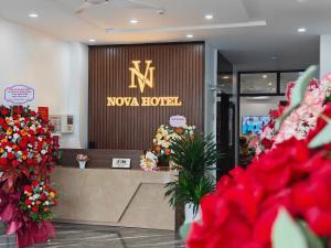 a lobby with a nyaoco lobby with red flowers at Nova Hotel 1 Phú Thọ in Chú Mật