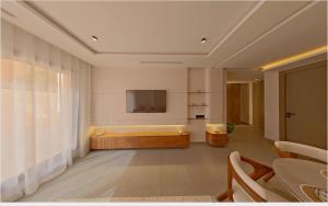 ein Wohnzimmer mit Badewanne und Fernseher in der Unterkunft Appartement chic Menara Mall piscine Rooftop in Marrakesch