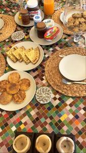a table with plates of food on top at Villa Serenity Marrakech in Châba