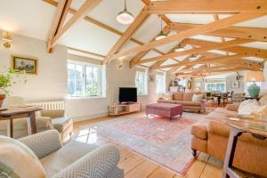 a large living room with wooden ceilings and a tv at 6 Bed in Tresillian oc-t32987 in Newlyn East
