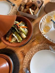 a table with plates and bowls of food and bread at Villa Serenity Marrakech in Châba