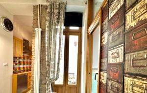 a room with a doorway with a window and a mirror at REALE COLOSSEUM HOME - private garden in Rome +15 photos
