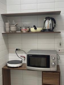 a microwave sitting on a counter in a kitchen at Dfour Home Ngõ Gạch - Old Quarter in Hanoi