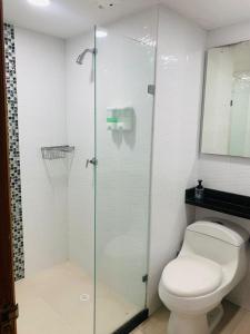 a bathroom with a toilet and a glass shower at apartamento 1302 in Cartagena de Indias