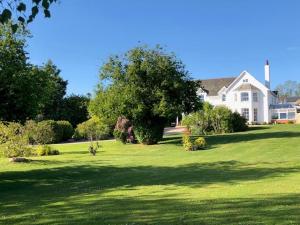 a large white house with a large grass yard at 1 Bed in Clyst Honiton oc-c32989 