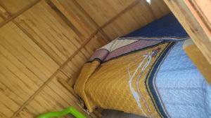 a bed in a room with a wooden ceiling at Fure Wassi Hostel in Cabanaconde +9 photos