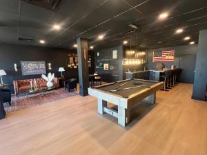 a room with a ping pong table and a bar at LIC Mgr - MODERN 3 BED 4 BATH VILLA - UPSCALE OCEANFRONT RESORT - INDOOR PICKLEBALL - SPEAKEASY! in Key Largo