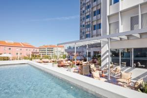 a swimming pool on the roof of a building at Hotel Acta Moa in Lisbon