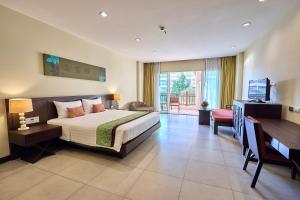 a bedroom with a bed and a desk and a television at The Heritage Pattaya Beachfront Resort in Pattaya South +101 photos