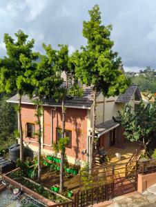 a house with trees in front of it at Pleasant Stay Coonoor-A Serene Hillside Retreat in Coonoor +19 photos