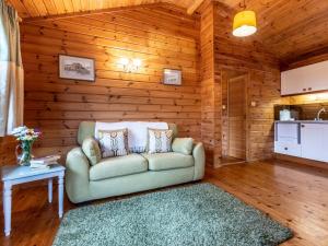 a living room with a couch and a table at 1 Bed in Clovelly 00355 in Clovelly +6 photos