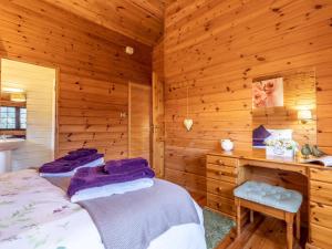 a bedroom with two beds in a log cabin at 1 Bed in Clovelly 00355 in Clovelly
