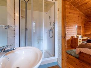 a bathroom with a shower and a white sink at 1 Bed in Clovelly 00355 in Clovelly