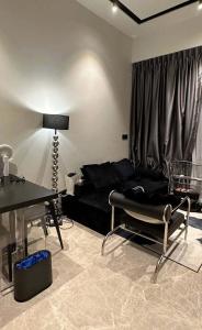 a living room with a black couch and a table at NICOLE's travel room in Fontana