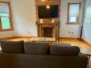 a living room with a couch and a flat screen tv at Free Parking - Prime Location - Downtown in Columbus