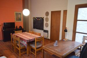 a dining room with a table and chairs and a television at Department RJ in San Rafael