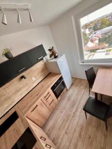 a living room with a television and a table and a window at Apartmán Dona in Veľký Meder