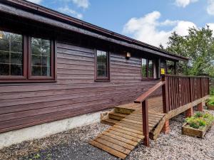 a house with a wooden staircase leading to a porch at 3 Bed in Clovelly 00374 in Clovelly