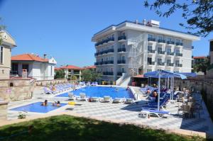 a swimming pool in front of a hotel at Elisa Hotel in Ayvalık