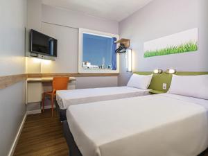 Postel nebo postele na pokoji v ubytování Ibis Budget Fortaleza Praia de Iracema