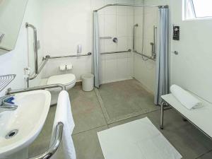 a bathroom with a shower and a sink and a toilet at Ibis Budget Fortaleza Praia de Iracema in Fortaleza +78 photos