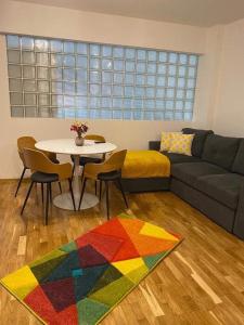 a living room with a table and a couch at Yvett Studio-Fortuna Park in Sfântu-Gheorghe +11 photos