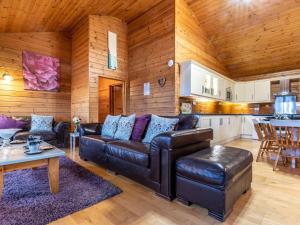 a living room with a couch and a table and a kitchen at 4 Bed in Clovelly 00360 in Clovelly
