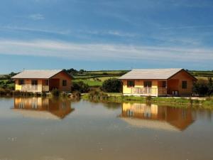 two houses sitting next to a body of water at 2 Bed in Clovelly 00362 in Clovelly +10 photos