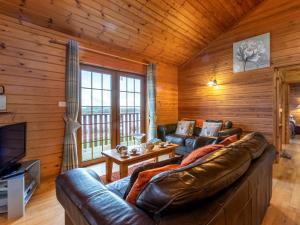 a living room with a leather couch and a television at 3 Bed in Clovelly 00359 in Clovelly
