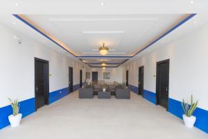 an empty hallway with blue and white walls and black doors at The Strype Hotel Tagaytay in Tagaytay