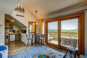 a kitchen with a table and chairs and a balcony at Top Of Seven in Seven Devils +57 photos