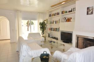 a living room with white furniture and a fireplace at RNET - Port Primer Empuriabrava in Empuriabrava