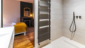 a bathroom with a shower and a bed in a room at L'orée du Parc in Longvic +41 photos