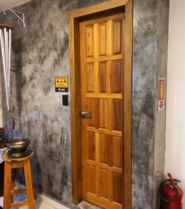 a wooden door in a room with a wall at Pousada GPC in Macaé