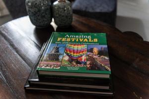 a stack of books sitting on top of a table at Little Noone in Jackson