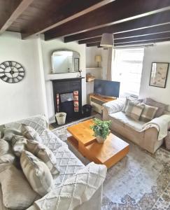 a living room with a couch and a table at Church view Cottage in Osmotherley +19 photos