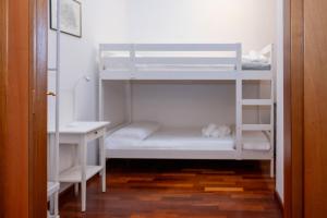 a room with two bunk beds and a desk at Villa d'Este - Historic City Villa with WiFi & Air Conditioning in Ferrara