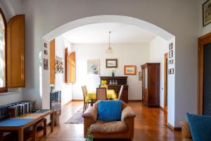 a living room with a table and chairs at Villa d'Este - Historic City Villa with WiFi & Air Conditioning in Ferrara