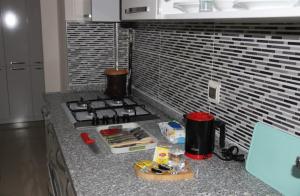 a kitchen counter with a stove and a sink at butik konaklama in Aksaray