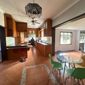 a kitchen with a table and some chairs in it at MBT Lodge in Polokwane +51 photos