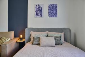 a bedroom with a bed and a couch and a picture at Apartment Mostecka in Prague