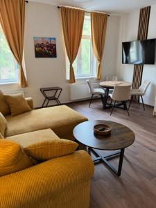 a living room with a couch and a table at Samaya Apartment in Litoměřice