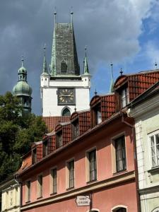a building with a clock tower on top of it at Samaya Apartment in Litoměřice