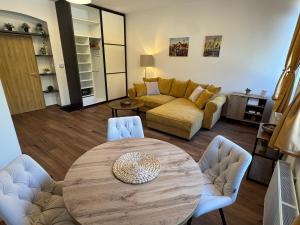 a living room with a table and a couch at Samaya Apartment in Litoměřice