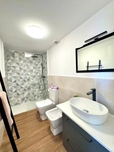 a bathroom with a sink and a toilet and a mirror at Casa Morena in Costa de Antigua +27 photos