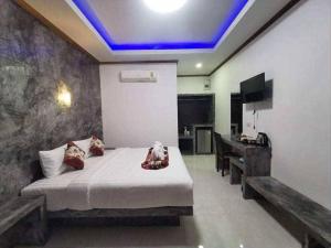 a bedroom with a bed and a piano in a room at Laila Places at Lanta in Ko Lanta