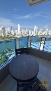 a table in a balcony with a view of a city at apartamento 2 baños in Cartagena de Indias