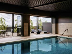 a house with a swimming pool and a patio at Mercure Melbourne Doncaster in Doncaster