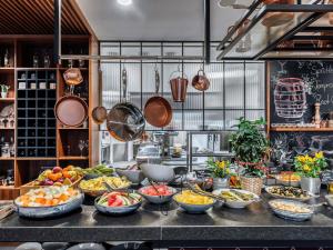 a buffet with many bowls of food on a counter at Mercure Katowice Centrum in Katowice